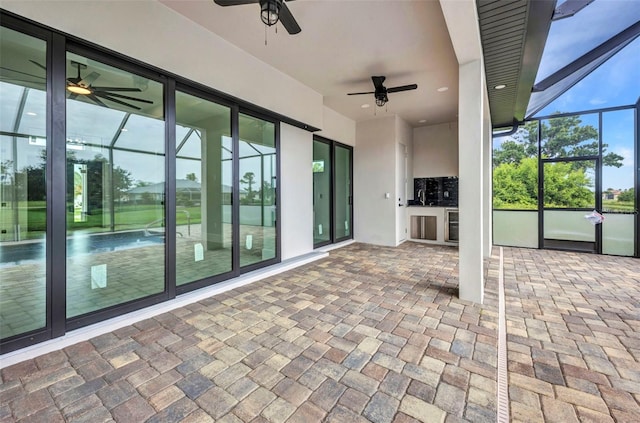 15 Tournament Rd, Rotonda West, FL 33947 - unfurnished sunroom with a ceiling fan and wine cooler