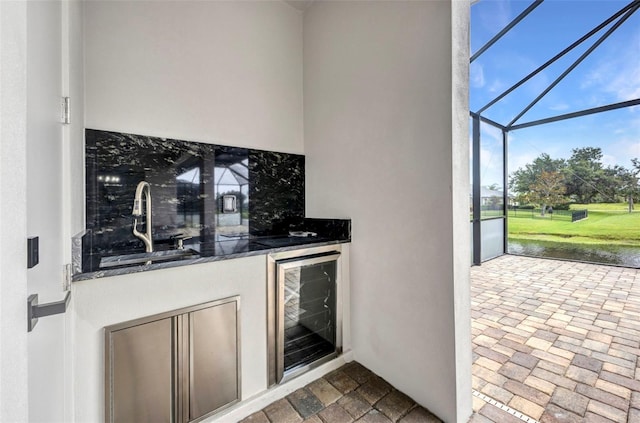15 Tournament Rd, Rotonda West, FL 33947 - indoor wet bar featuring beverage cooler and brick floors