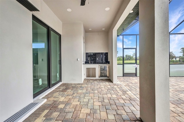 15 Tournament Rd, Rotonda West, FL 33947 - view of patio with glass enclosure and beverage cooler
