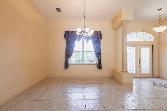 25538 Rampart Blvd, Punta Gorda, FL 33983 - foyer featuring decorative columns, a chandelier, light tile patterned floors, and baseboards