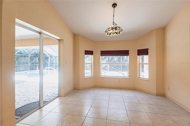 25538 Rampart Blvd, Punta Gorda, FL 33983 - spare room featuring light tile patterned floors, baseboards, and a textured ceiling