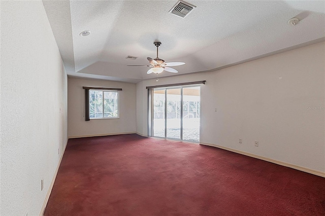 25538 Rampart Blvd, Punta Gorda, FL 33983 - carpeted empty room with a ceiling fan, a tray ceiling, baseboards, and a textured ceiling