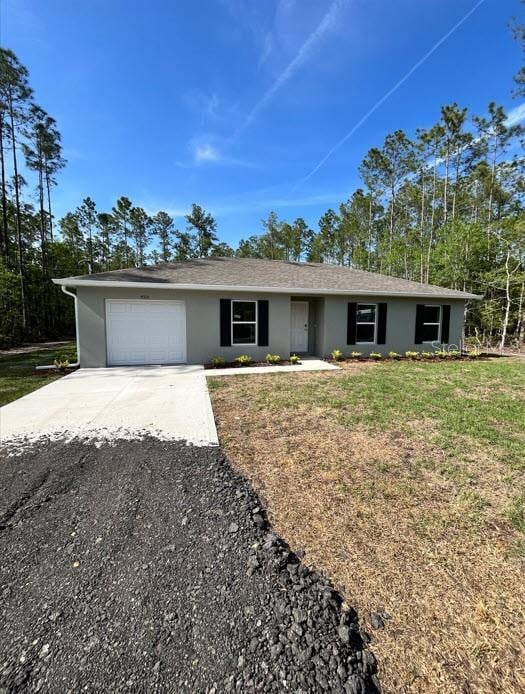 4310 Alvin St, Hastings, FL 32145 - ranch-style home featuring concrete driveway, a garage, stucco siding, and a front yard