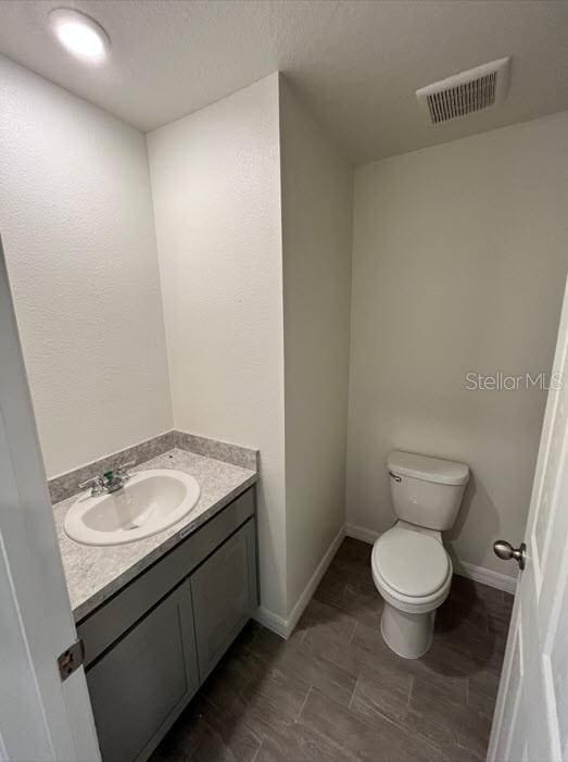 4310 Alvin St, Hastings, FL 32145 - bathroom featuring toilet, vanity, and baseboards