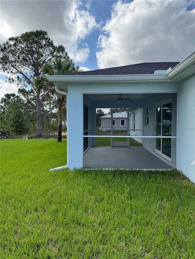 6274 Skyview Dr, North Port, FL 34291 - back of house with a lawn, a patio, stucco siding, a sunroom, and ceiling fan