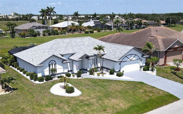7148 N Blue Sage, Punta Gorda, FL 33955 - view of front of house with stucco siding, an attached garage, driveway, and a residential view