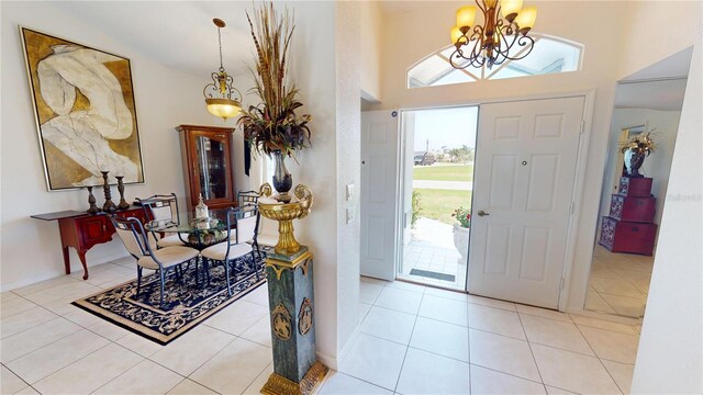 7148 N Blue Sage, Punta Gorda, FL 33955 - entrance foyer featuring a chandelier, tile patterned flooring, and a towering ceiling
