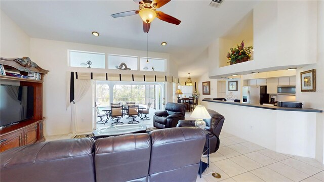 7148 N Blue Sage, Punta Gorda, FL 33955 - living room featuring a towering ceiling, light tile patterned flooring, and a ceiling fan