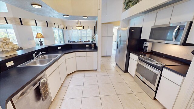 7148 N Blue Sage, Punta Gorda, FL 33955 - kitchen featuring stainless steel appliances, a sink, dark countertops, and light tile patterned floors