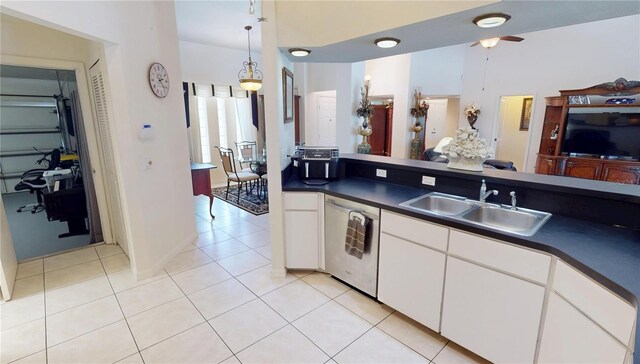 7148 N Blue Sage, Punta Gorda, FL 33955 - kitchen with a sink, dishwasher, dark countertops, light tile patterned flooring, and white cabinetry