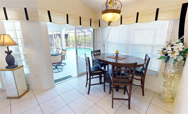 7148 N Blue Sage, Punta Gorda, FL 33955 - dining room with healthy amount of natural light, baseboards, light tile patterned floors, and vaulted ceiling