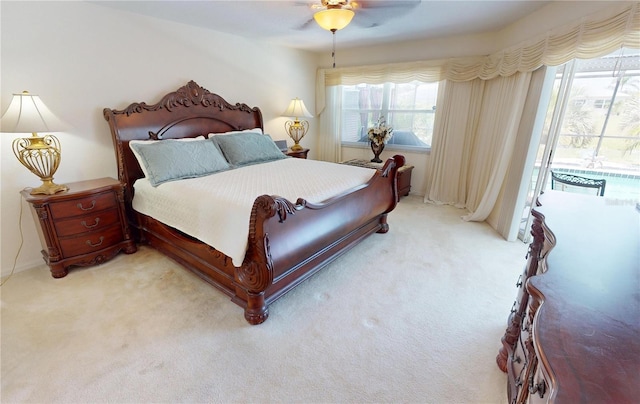 7148 N Blue Sage, Punta Gorda, FL 33955 - bedroom with access to exterior, light carpet, and multiple windows