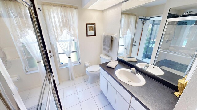 7148 N Blue Sage, Punta Gorda, FL 33955 - bathroom with a stall shower, tile patterned flooring, toilet, vanity, and baseboards