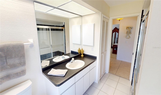7148 N Blue Sage, Punta Gorda, FL 33955 - bathroom with tile patterned floors, toilet, vanity, and an enclosed shower