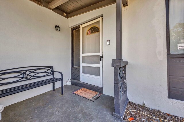 2465 Deedra St, Port Charlotte, FL 33952 - doorway to property featuring stucco siding and covered porch