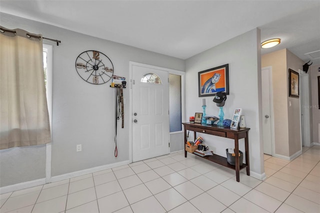 2465 Deedra St, Port Charlotte, FL 33952 - foyer entrance with plenty of natural light, baseboards, and light tile patterned floors