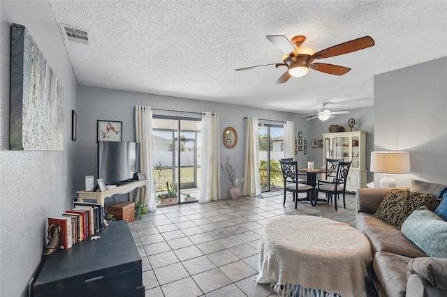 4358 Pates St, Port Charlotte, FL 33948 - tiled living area featuring a ceiling fan and a textured ceiling