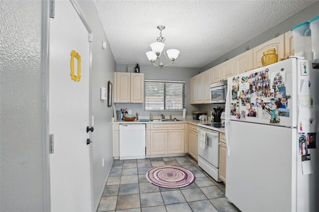 4358 Pates St, Port Charlotte, FL 33948 - kitchen featuring white appliances, a chandelier, light countertops, light brown cabinetry, and a textured ceiling