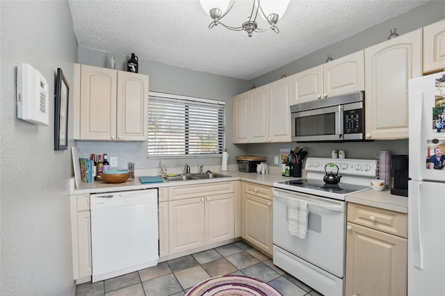 4358 Pates St, Port Charlotte, FL 33948 - kitchen with white appliances, a sink, light countertops, a textured ceiling, and a chandelier