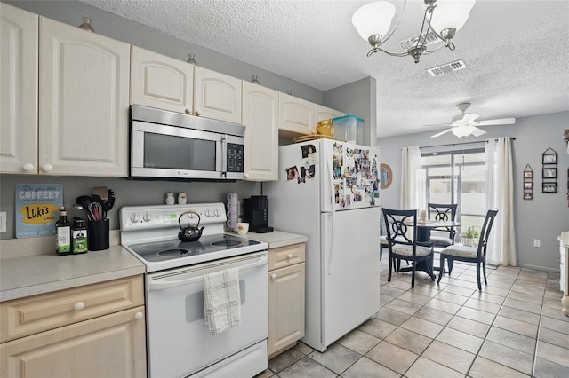 4358 Pates St, Port Charlotte, FL 33948 - kitchen with white appliances, a chandelier, a textured ceiling, ceiling fan, and light countertops
