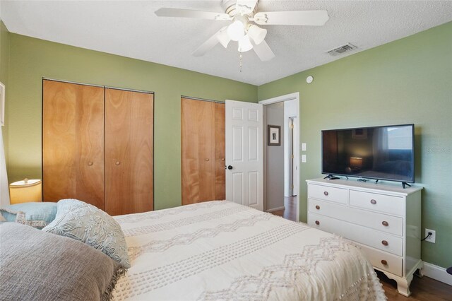 4358 Pates St, Port Charlotte, FL 33948 - bedroom with multiple closets, dark wood finished floors, baseboards, and a ceiling fan