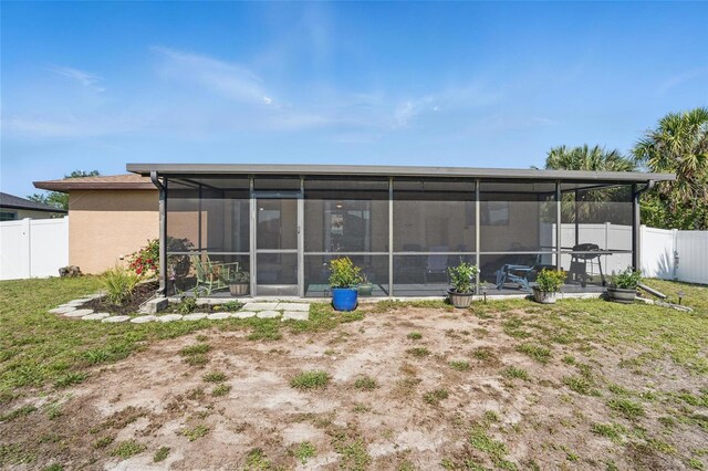 4358 Pates St, Port Charlotte, FL 33948 - back of house featuring a sunroom, a fenced backyard, and stucco siding