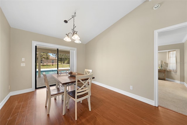 1039 Marlene St, Port Charlotte, FL 33952 - dining room featuring baseboards, wood finished floors, lofted ceiling, and a chandelier