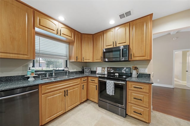 1039 Marlene St, Port Charlotte, FL 33952 - kitchen with appliances with stainless steel finishes, a sink, dark stone counters, baseboards, and recessed lighting