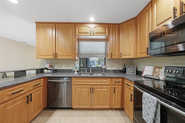 1039 Marlene St, Port Charlotte, FL 33952 - kitchen with appliances with stainless steel finishes, a sink, dark stone countertops, and recessed lighting