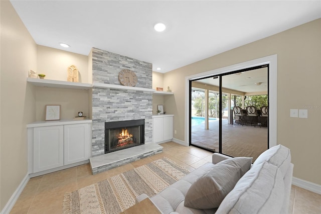1039 Marlene St, Port Charlotte, FL 33952 - living room featuring light tile patterned floors, a stone fireplace, baseboards, and recessed lighting