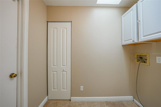 1039 Marlene St, Port Charlotte, FL 33952 - laundry room featuring cabinet space, hookup for a washing machine, a skylight, and baseboards