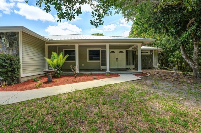 17340 Oak Creek Rd, Alva, FL 33920 - view of front of house with covered porch and metal roof