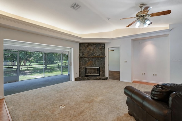 17340 Oak Creek Rd, Alva, FL 33920 - carpeted living room with a raised ceiling, ceiling fan, a fireplace, and baseboards