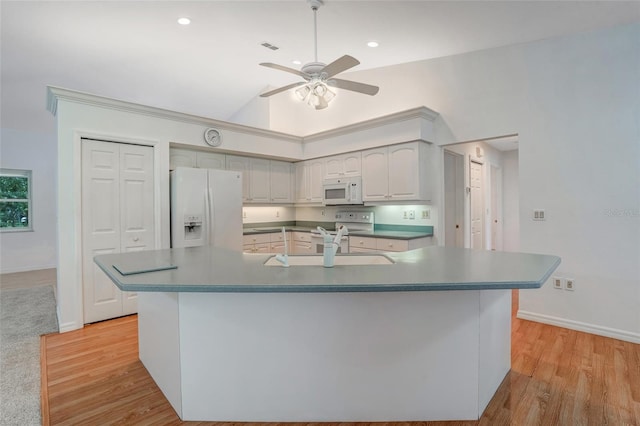 17340 Oak Creek Rd, Alva, FL 33920 - kitchen featuring white appliances, a sink, ceiling fan, vaulted ceiling, and light wood finished floors