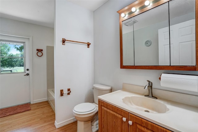 17340 Oak Creek Rd, Alva, FL 33920 - bathroom with wood finished floors, toilet, vanity, baseboards, and bathing tub / shower combination