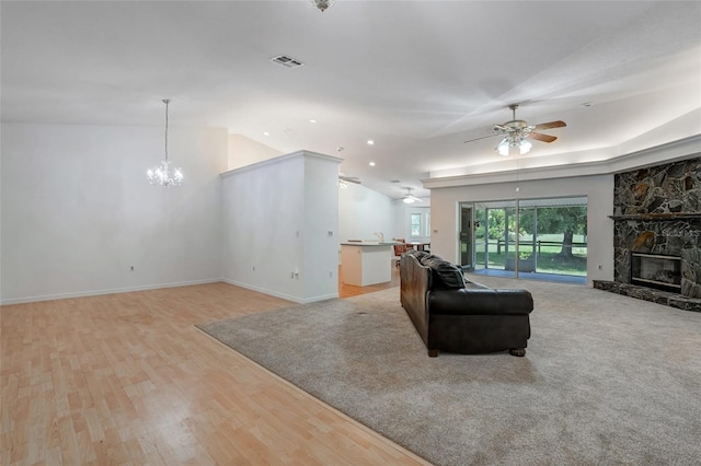 17340 Oak Creek Rd, Alva, FL 33920 - living room featuring ceiling fan, a chandelier, light wood-type flooring, a fireplace, and vaulted ceiling