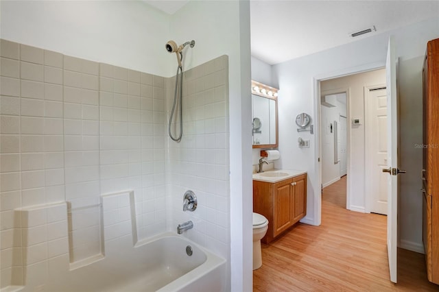17340 Oak Creek Rd, Alva, FL 33920 - bathroom with toilet, vanity, shower / bathtub combination, wood finished floors, and baseboards