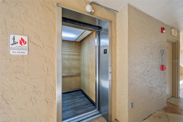 601 Shreve St Unit 21C, Punta Gorda, FL 33950 - elevator with a textured wall and a fire alarm