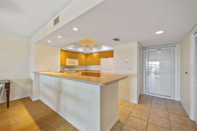 601 Shreve St Unit 21C, Punta Gorda, FL 33950 - kitchen with white appliances, a peninsula, baseboards, recessed lighting, and light countertops
