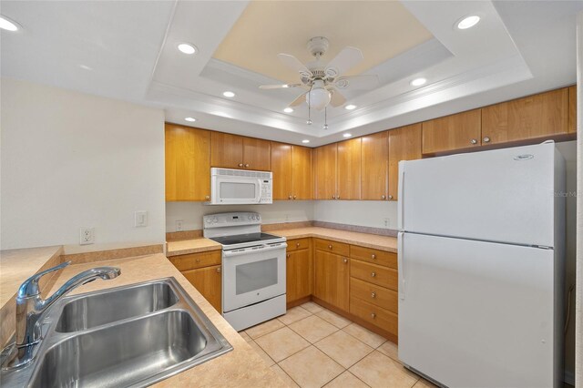 601 Shreve St Unit 21C, Punta Gorda, FL 33950 - kitchen featuring white appliances, a sink, a raised ceiling, recessed lighting, and light countertops