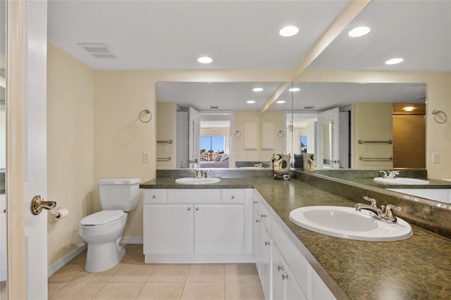 601 Shreve St Unit 21C, Punta Gorda, FL 33950 - bathroom featuring tile patterned flooring, toilet, double vanity, baseboards, and recessed lighting