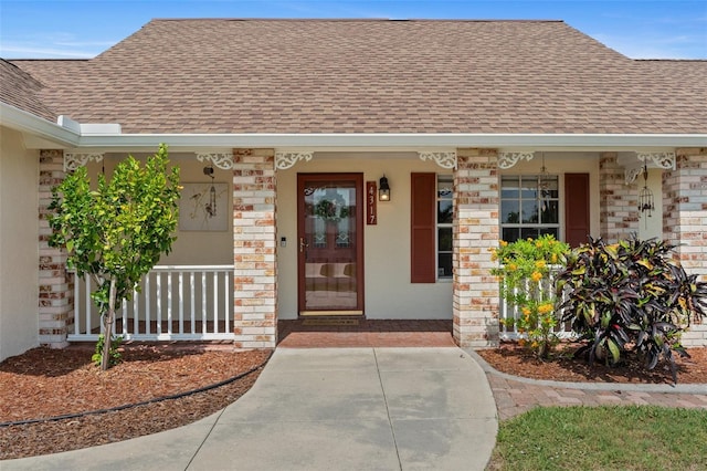 4317 Mccullough St, Port Charlotte, FL 33948 - doorway to property with a shingled roof, covered porch, and brick siding