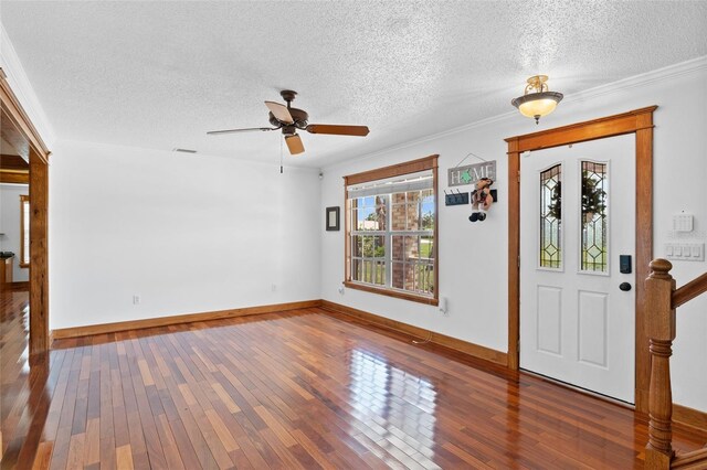 4317 Mccullough St, Port Charlotte, FL 33948 - foyer with a ceiling fan, hardwood / wood-style floors, a textured ceiling, baseboards, and ornamental molding