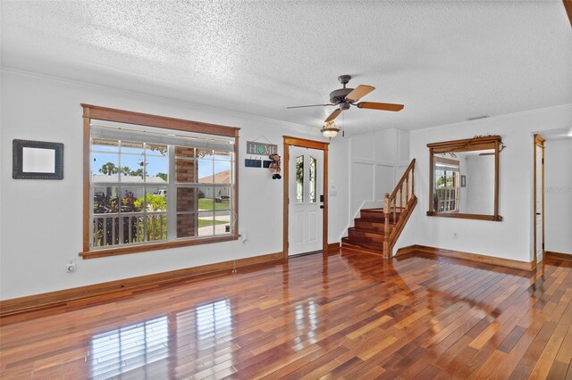 4317 Mccullough St, Port Charlotte, FL 33948 - foyer entrance with a textured ceiling, wood-type flooring, ceiling fan, stairs, and crown molding