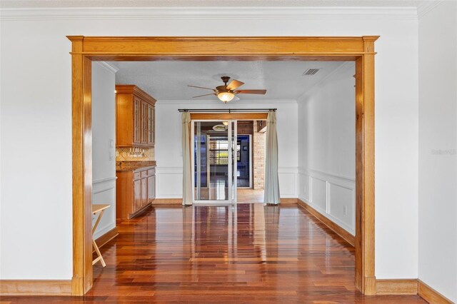 4317 Mccullough St, Port Charlotte, FL 33948 - unfurnished dining area with dark wood-style floors, ornamental molding, a ceiling fan, and a decorative wall