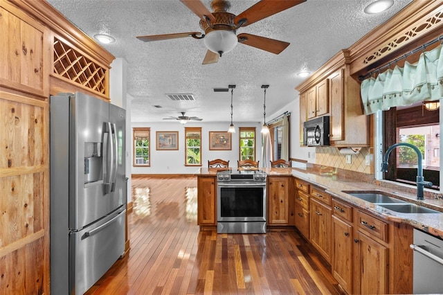 4317 Mccullough St, Port Charlotte, FL 33948 - kitchen featuring appliances with stainless steel finishes, a sink, a peninsula, ceiling fan, and healthy amount of natural light