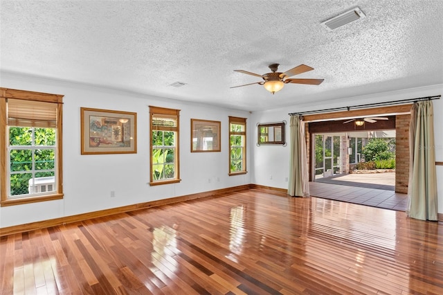 4317 Mccullough St, Port Charlotte, FL 33948 - spare room with a ceiling fan, wood-type flooring, plenty of natural light, and a textured ceiling
