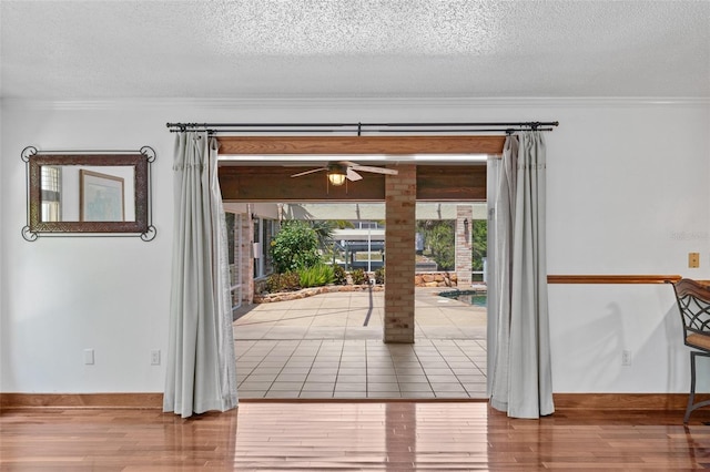 4317 Mccullough St, Port Charlotte, FL 33948 - doorway to outside featuring ceiling fan, ornamental molding, a textured ceiling, and wood finished floors