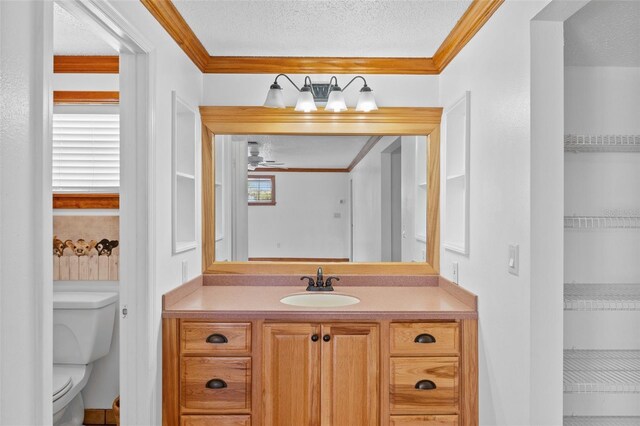 4317 Mccullough St, Port Charlotte, FL 33948 - bathroom with toilet, crown molding, vanity, a textured ceiling, and ceiling fan