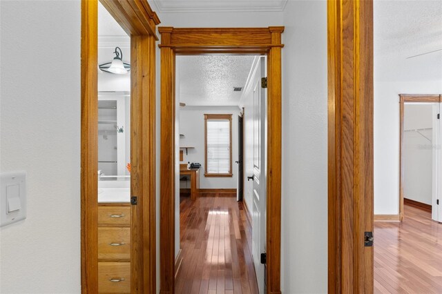 4317 Mccullough St, Port Charlotte, FL 33948 - hallway with hardwood / wood-style flooring, a textured ceiling, baseboards, and crown molding